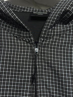 Black and white plaid zip-up hoodie front with centered zipper and chest seam details