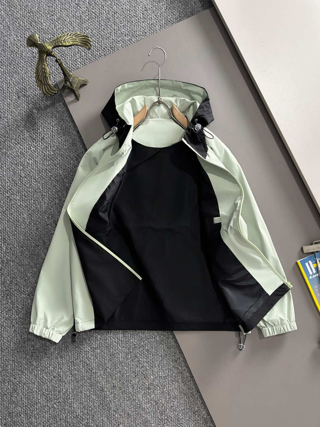 Two-tone mint and black hooded long jacket with front zip and drawcord pocket