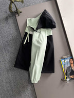 Mint and black hooded long jacket with two-tone panels and front drawstring