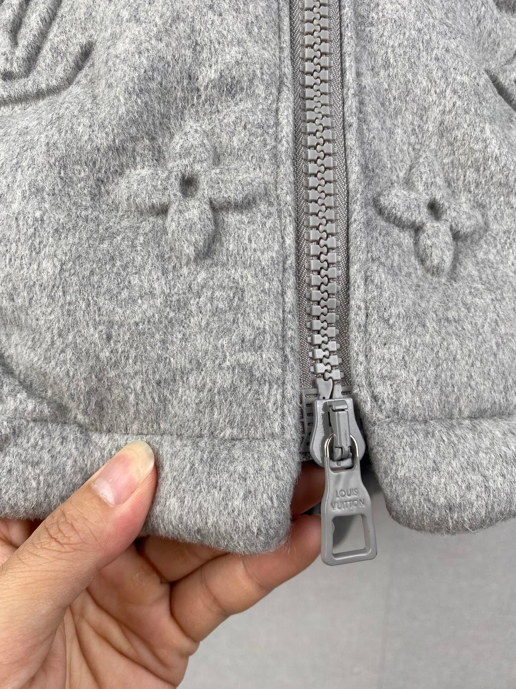Louis Vuitton hooded jacket close-up of front zipper and gray metal pull tab