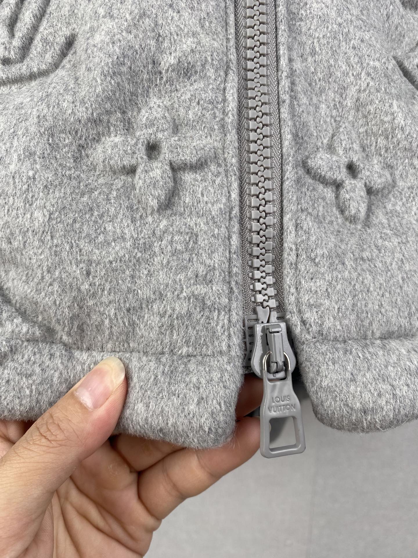 Louis Vuitton hooded jacket close-up of front zipper and gray metal pull tab