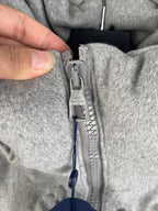Louis Vuitton zipper pull detail with logo tag on gray hooded jacket