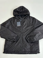 Dark navy hooded zip jacket with monogram-style pattern, front close-up