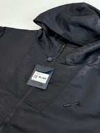Dark navy hooded jacket with zipper and hang tag, neckline and zipper close-up