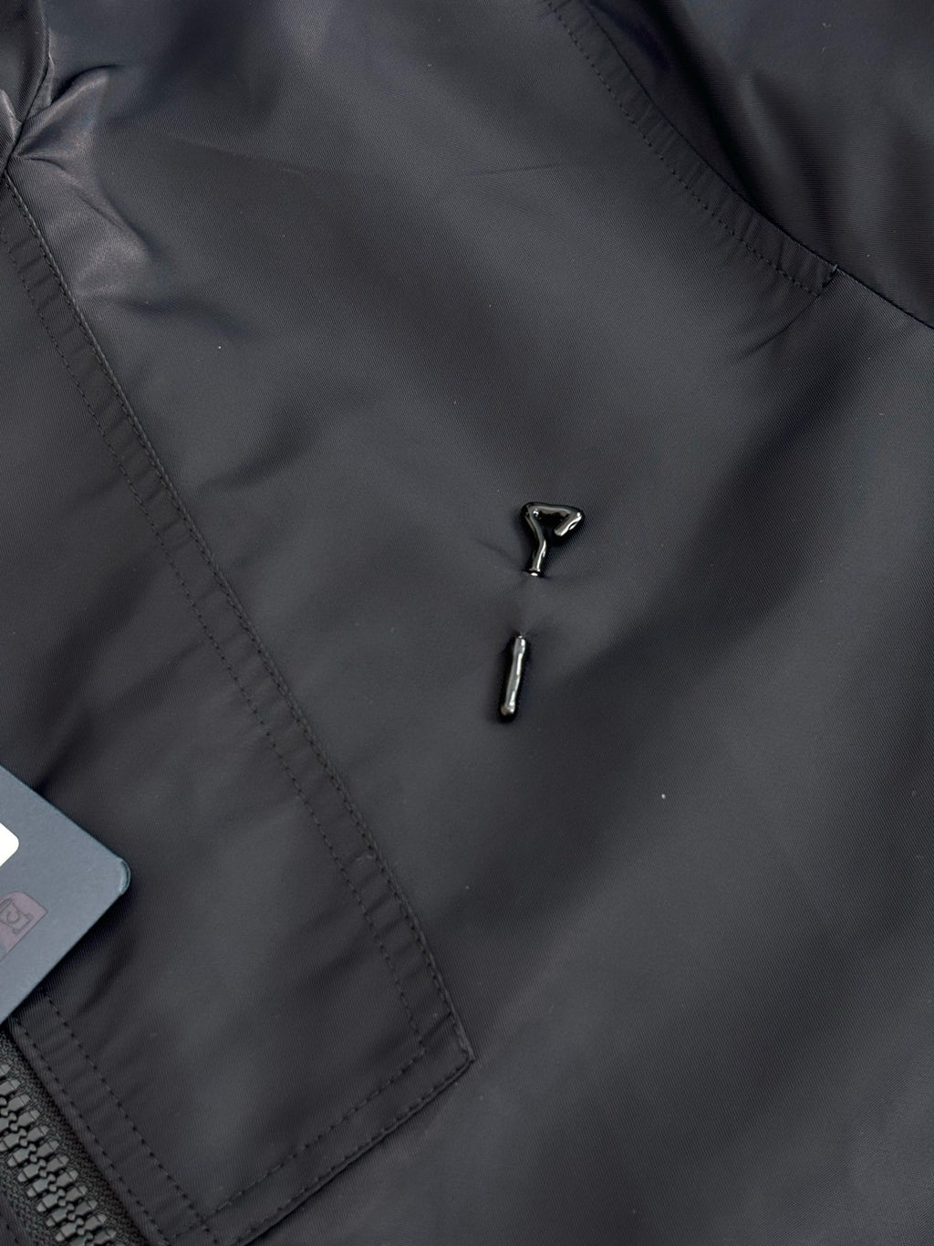 Louis Vuitton long coat front detail with stitched panel and two metal zipper pulls