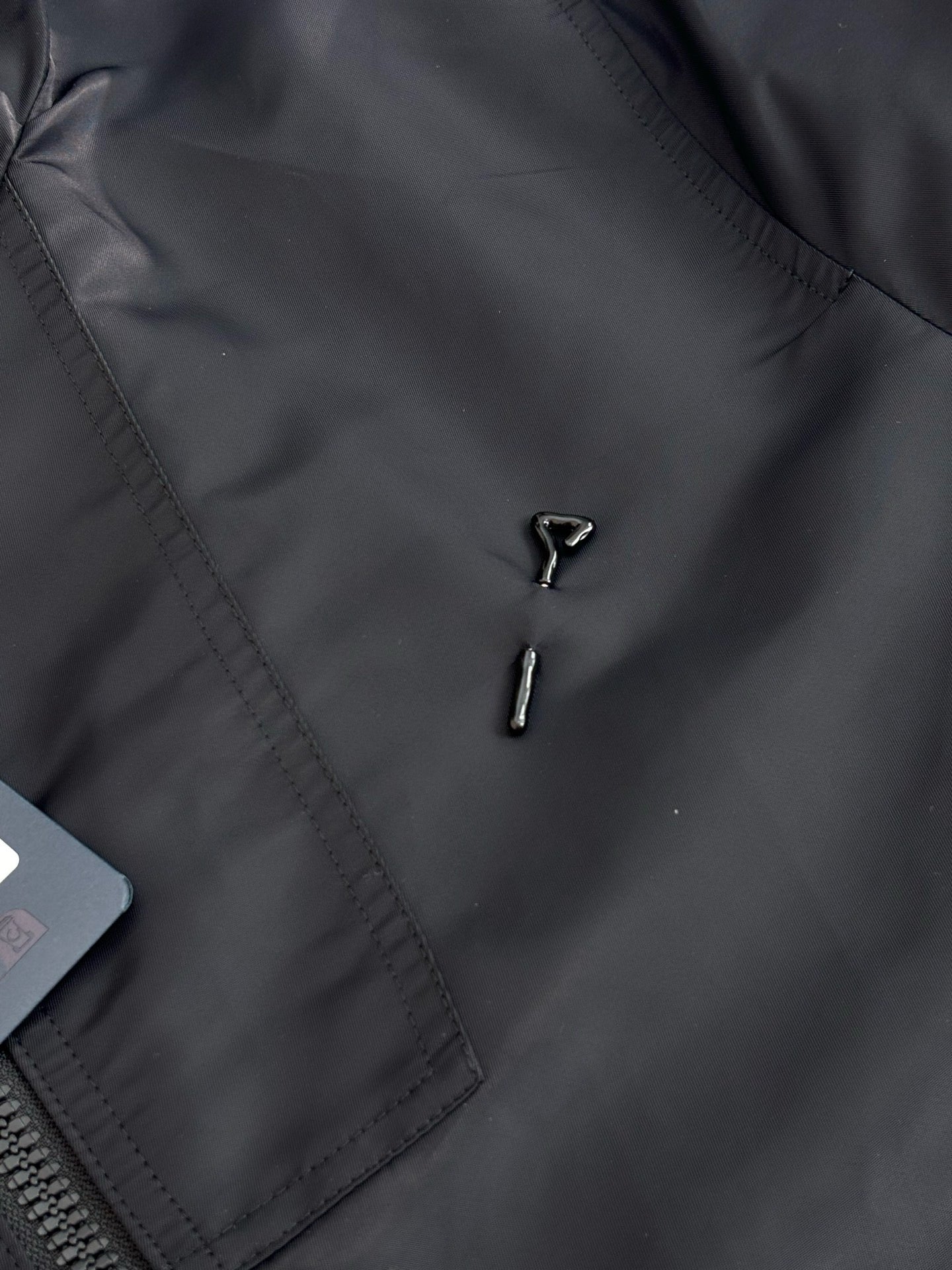 Louis Vuitton long coat front detail with stitched panel and two metal zipper pulls