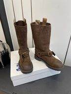 Dark brown suede tall boots with side buckles and low-profile sole, front view