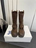 Dark brown suede tall boots with side buckle straps and low-profile rubber sole