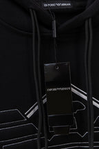 Black hoodie zipper area with drawstrings and hang tag