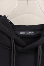 Black hoodie neck label with brand text inside collar