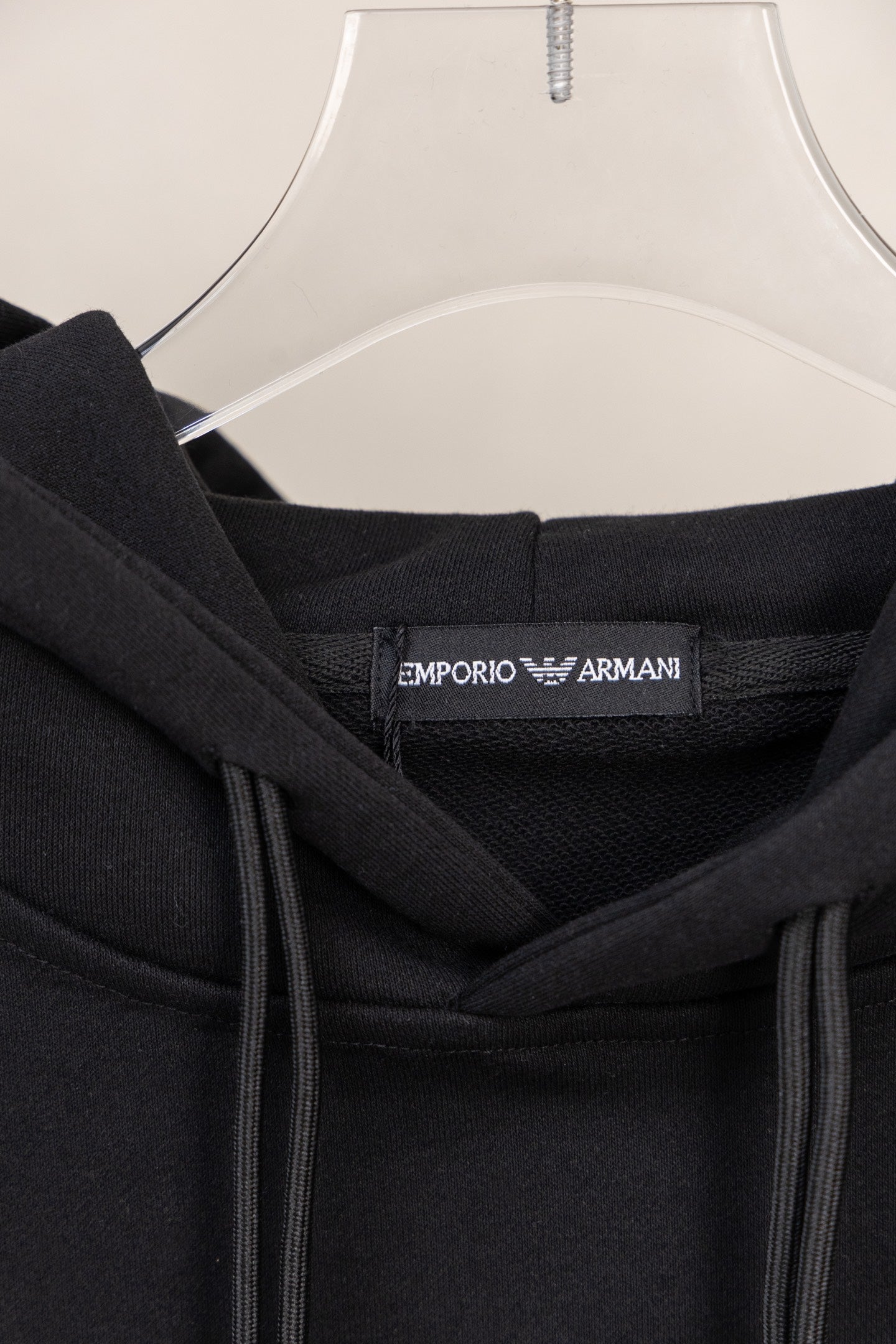 Black hoodie neck label with brand text inside collar