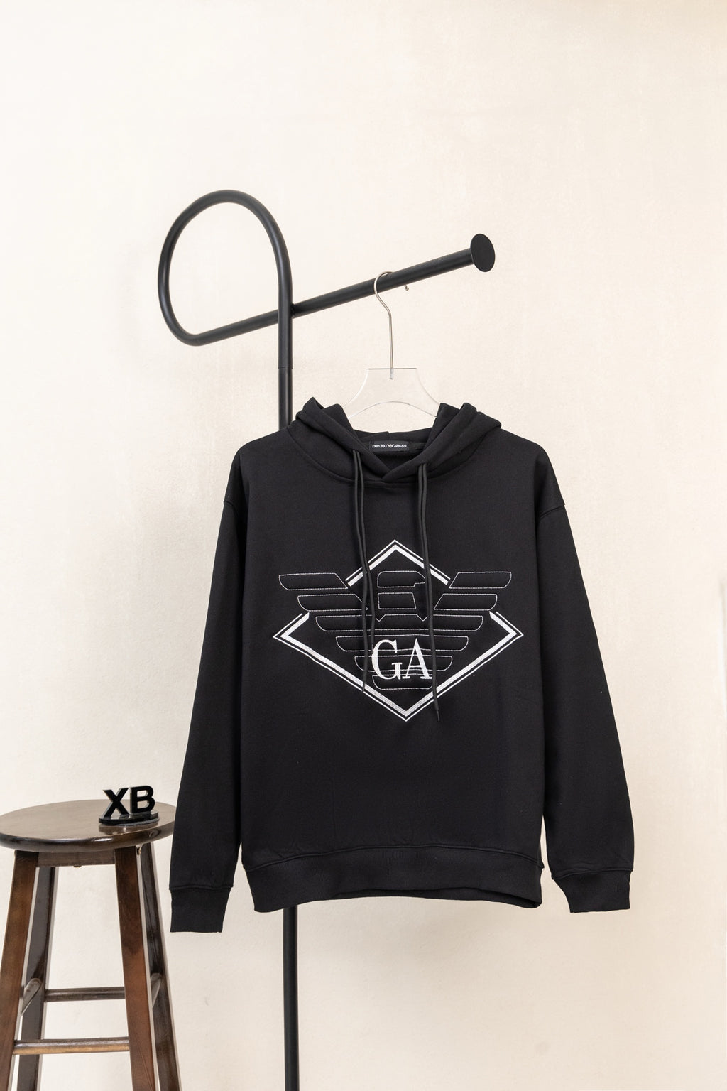 Black pullover hoodie with large chest logo print and drawstring hood