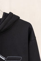 Black hoodie side view with small logo line detail on sleeve
