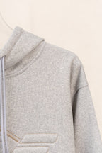 Amiri hoodie side view in light gray heather with ribbed hem and smooth fabric