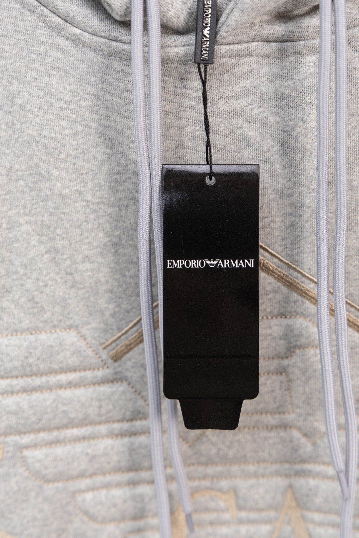 Amiri hoodie with drawstrings and hanging Emporio Armani brand tag
