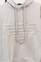 Amiri hoodie in light gray heather with embroidered V logo and drawstring hood