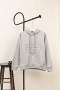 Amiri hoodie in light gray heather with hood, drawstring, and front pouch pocket