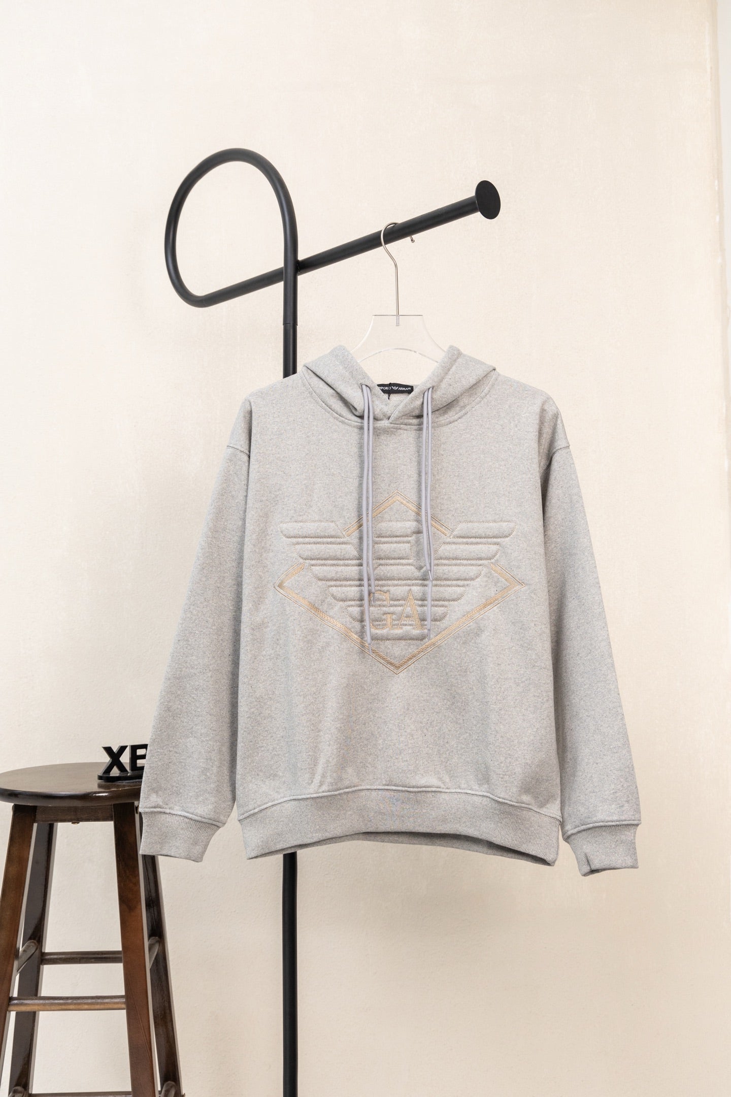 Amiri hoodie in light gray heather with hood, drawstring, and front pouch pocket