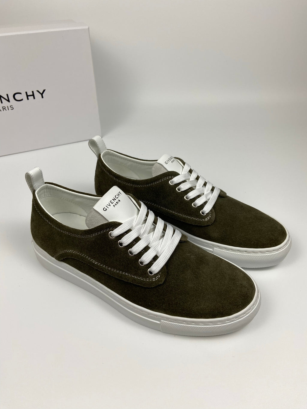 Olive suede low-top sneakers with white laces, white midsole, and Givenchy logo details.