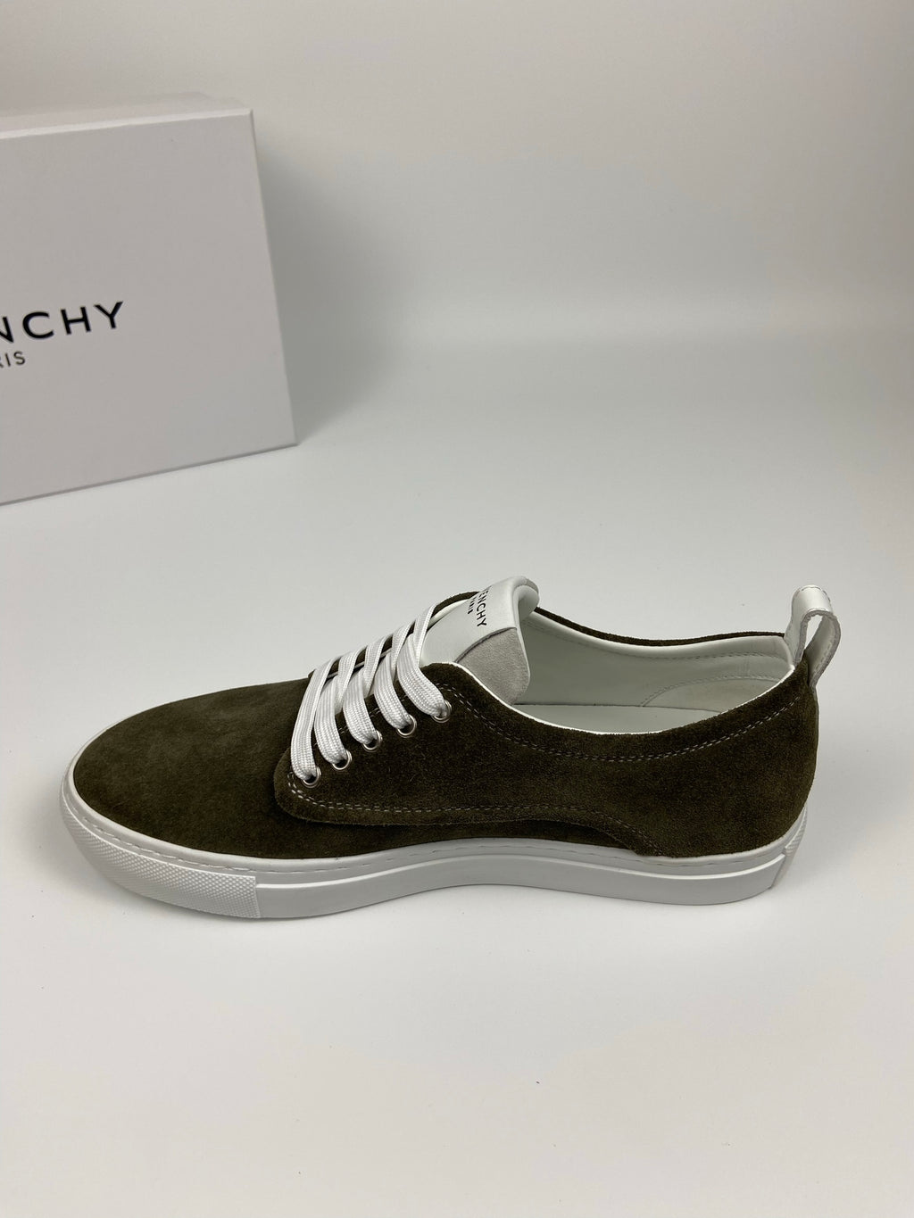 Olive suede sneaker with white laces and white rubber sole, front side view.