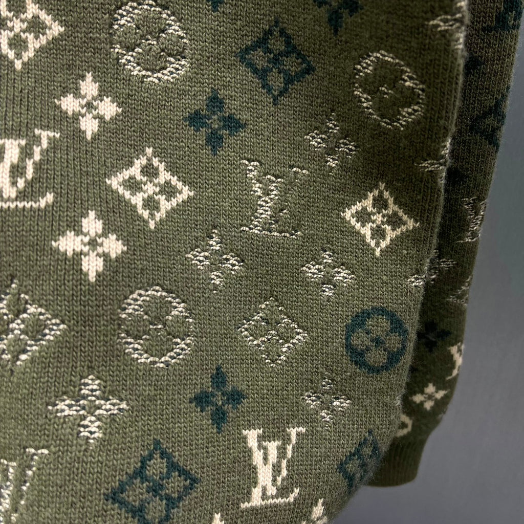 Side sleeve fabric close-up on dark olive knit sweater with LV monogram print