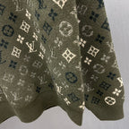 Close-up of long-sleeve sweater knit with LV monogram and geometric motifs
