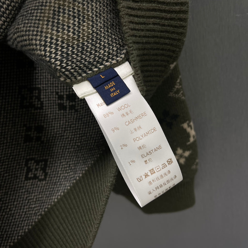 Clothing care label on knit sweater listing fiber blend including cashmere and elastane