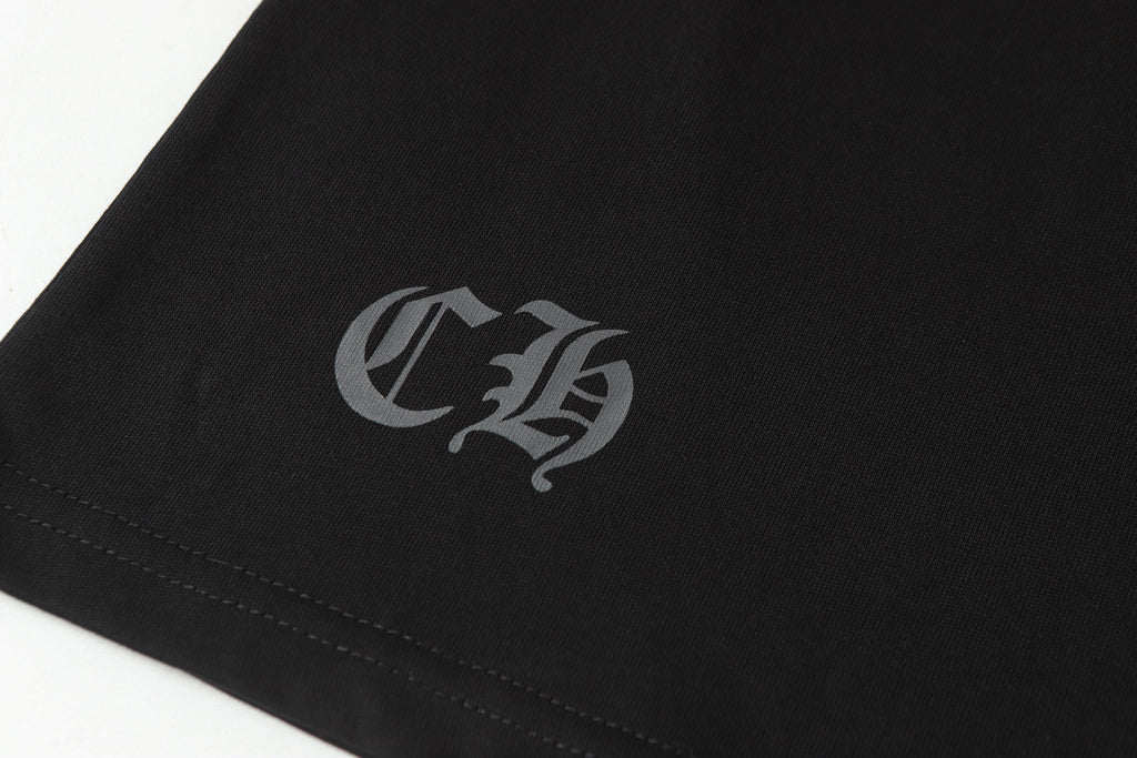 Black long-sleeve shirt sleeve cuff with small gray monogram emblem