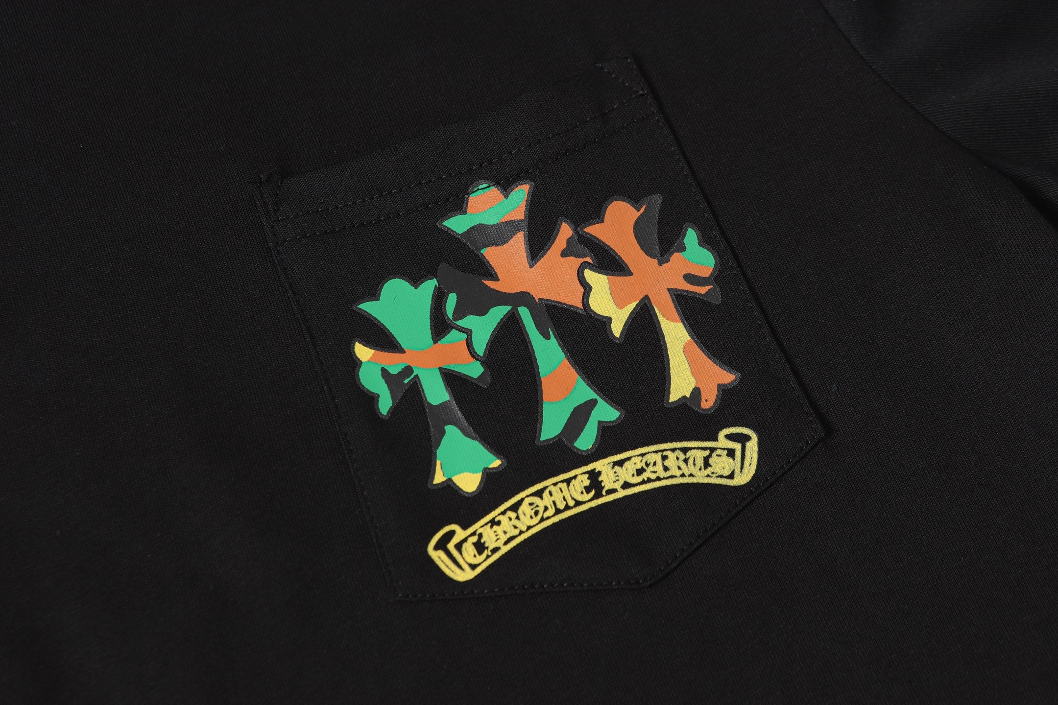 Black long-sleeve shirt with colorful patch graphic on the chest