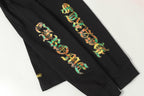 Black long-sleeve shirt sleeve graphic artwork, shown in a close crop