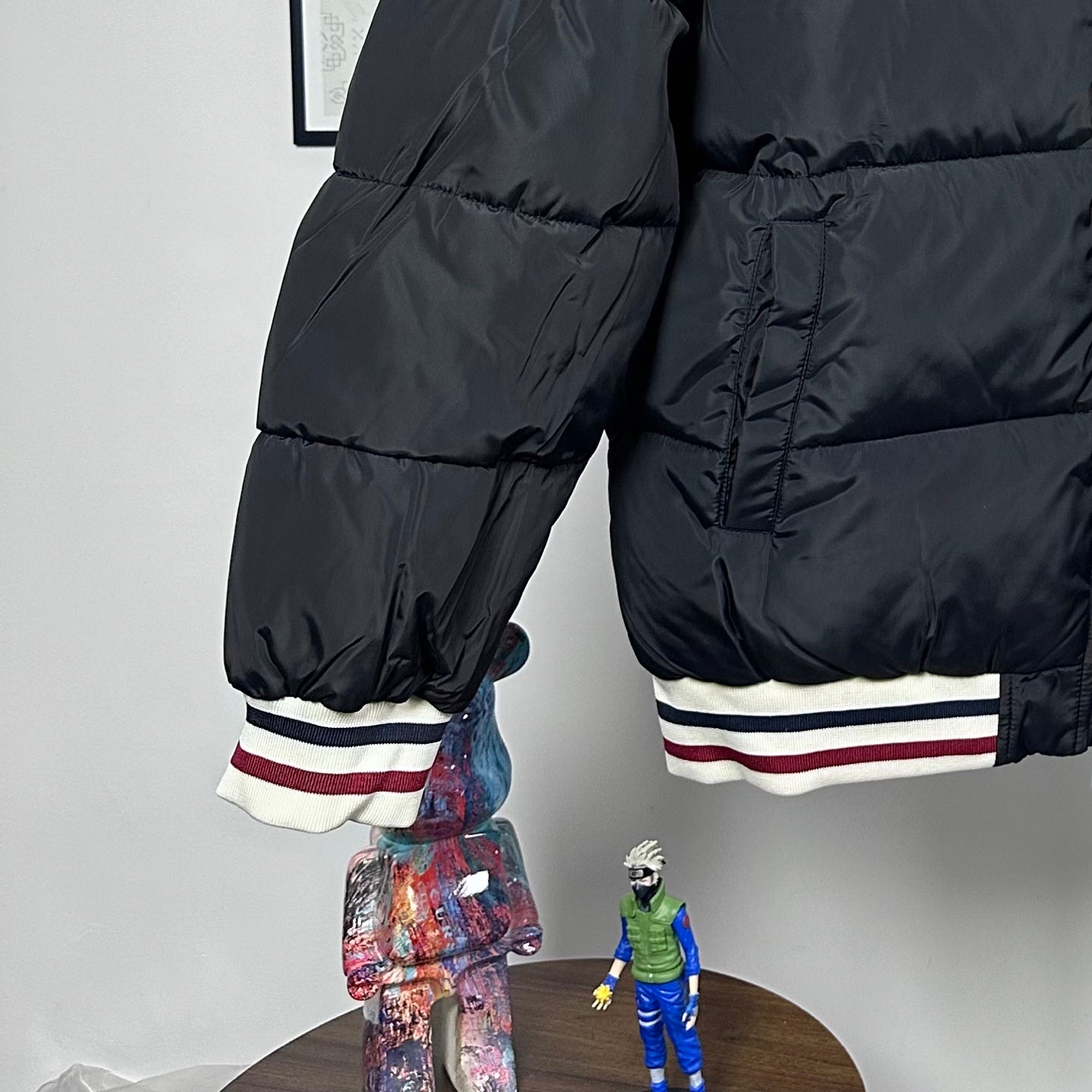 Moncler quilted puffer jacket with striped cuffs and stitched paneling