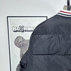 Moncler long puffer jacket, black quilted front and zipper with striped trim cuff