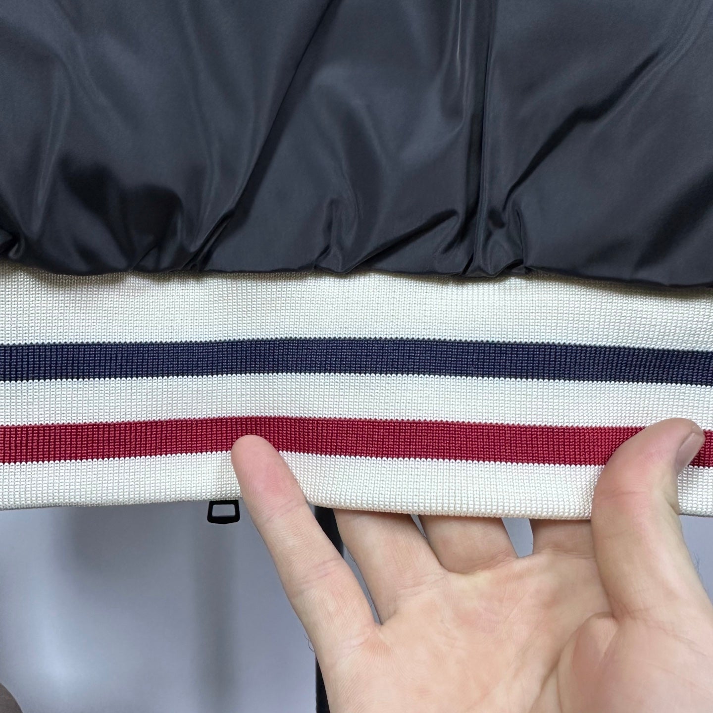 Moncler puffer jacket hem with wide striped ribbed band