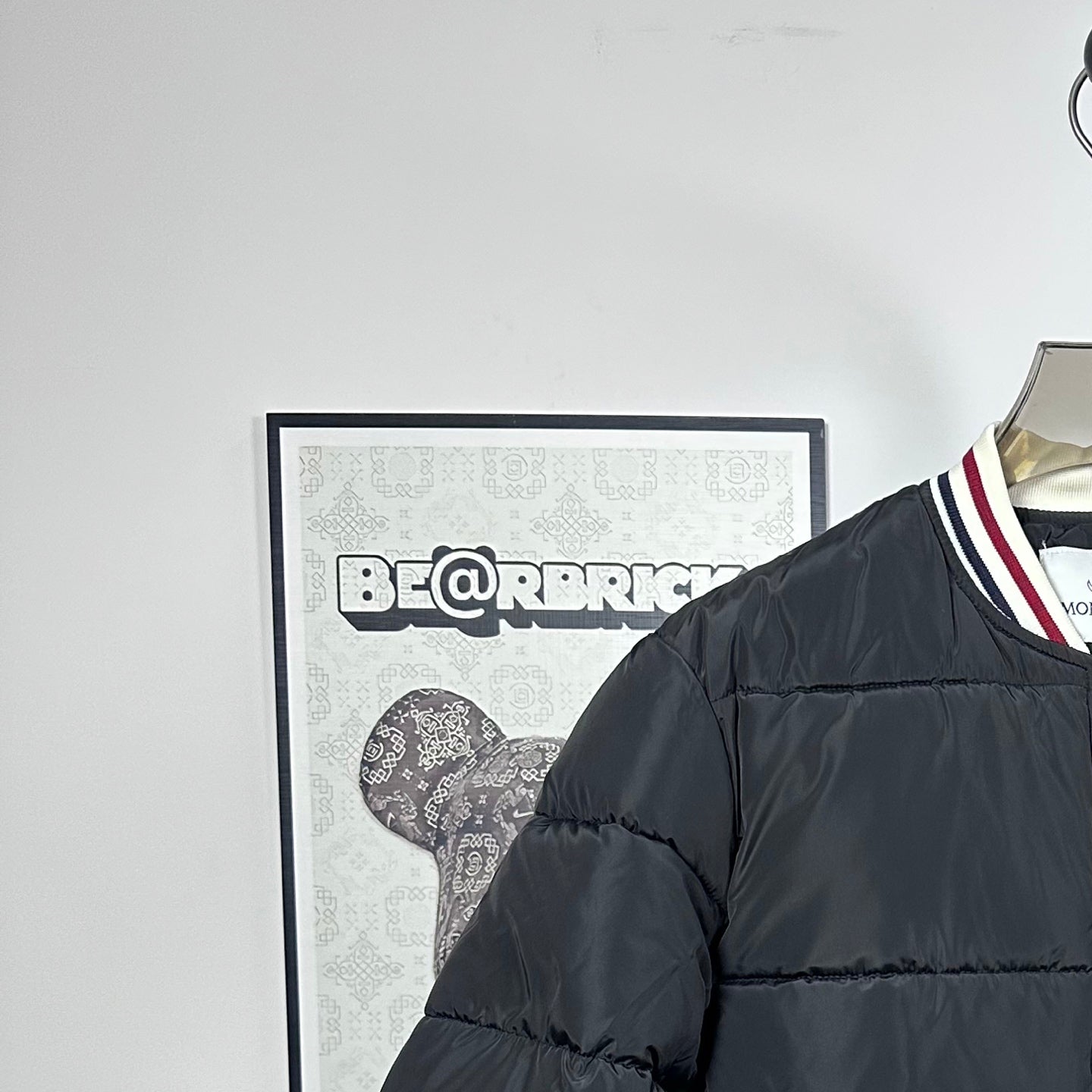 Moncler puffer jacket shoulder and collar with striped trim