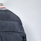 Moncler long puffer jacket sleeve, black quilted panel and ribbed striped cuff