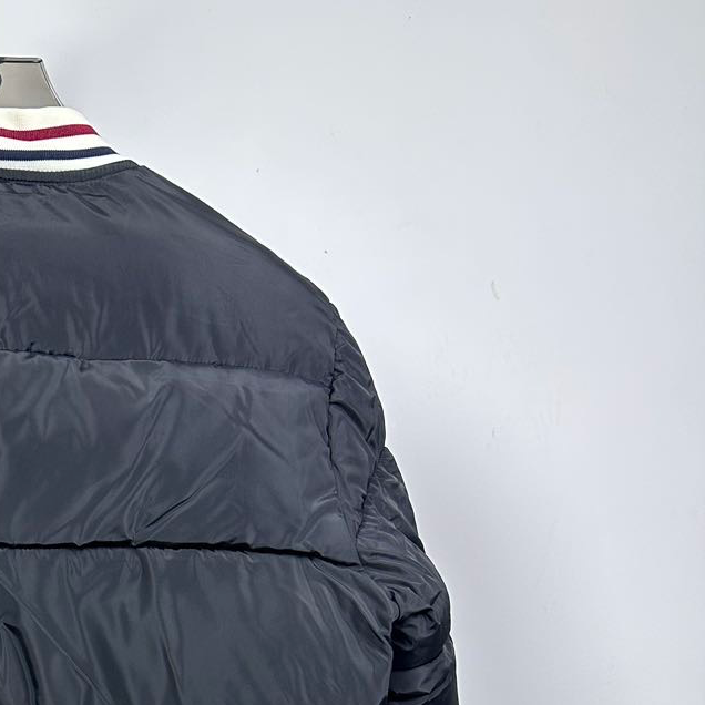 Moncler long puffer jacket sleeve, black quilted panel and ribbed striped cuff
