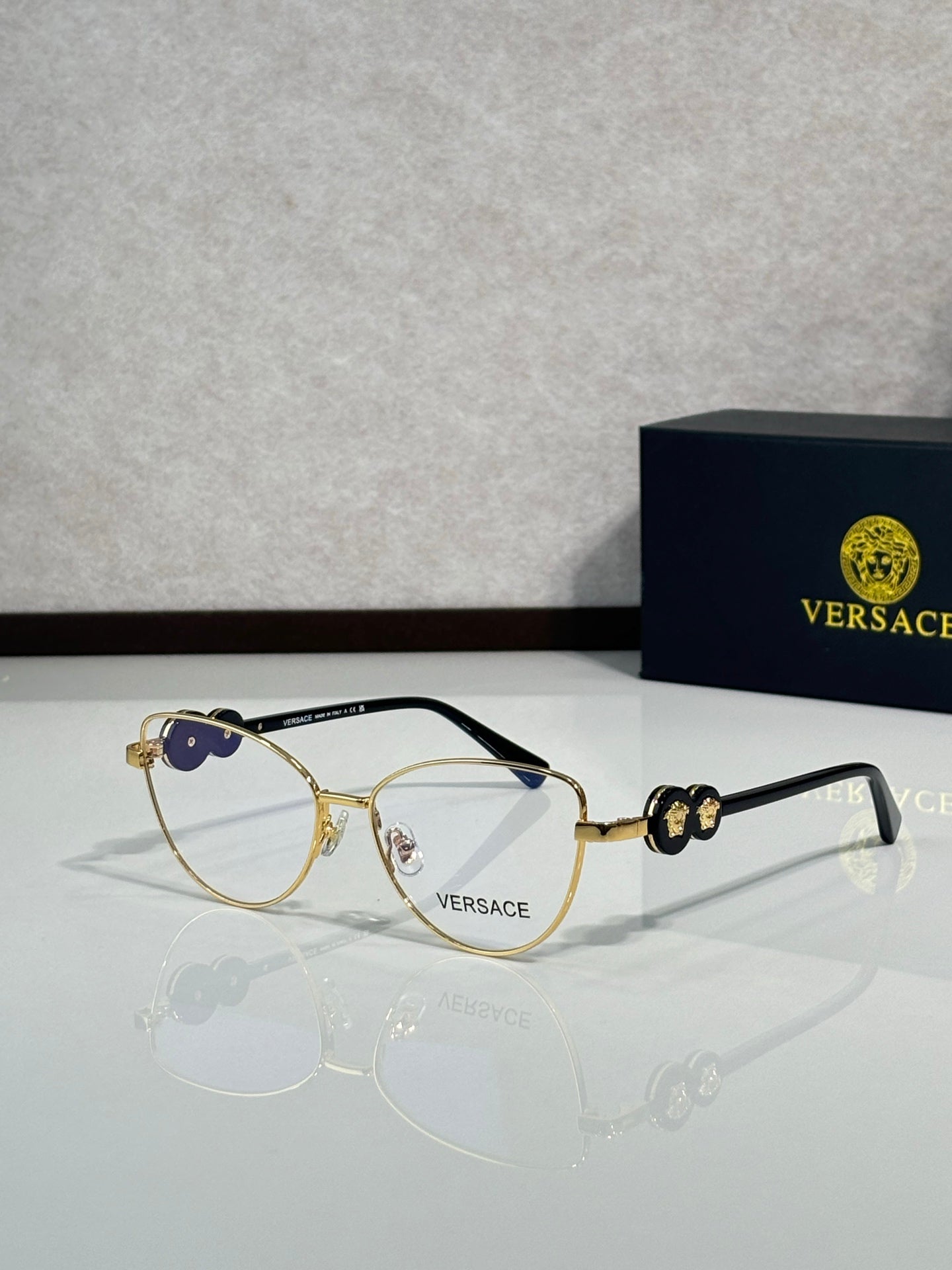 Versace aviator sunglasses with gold-tone frame and dark blue lenses