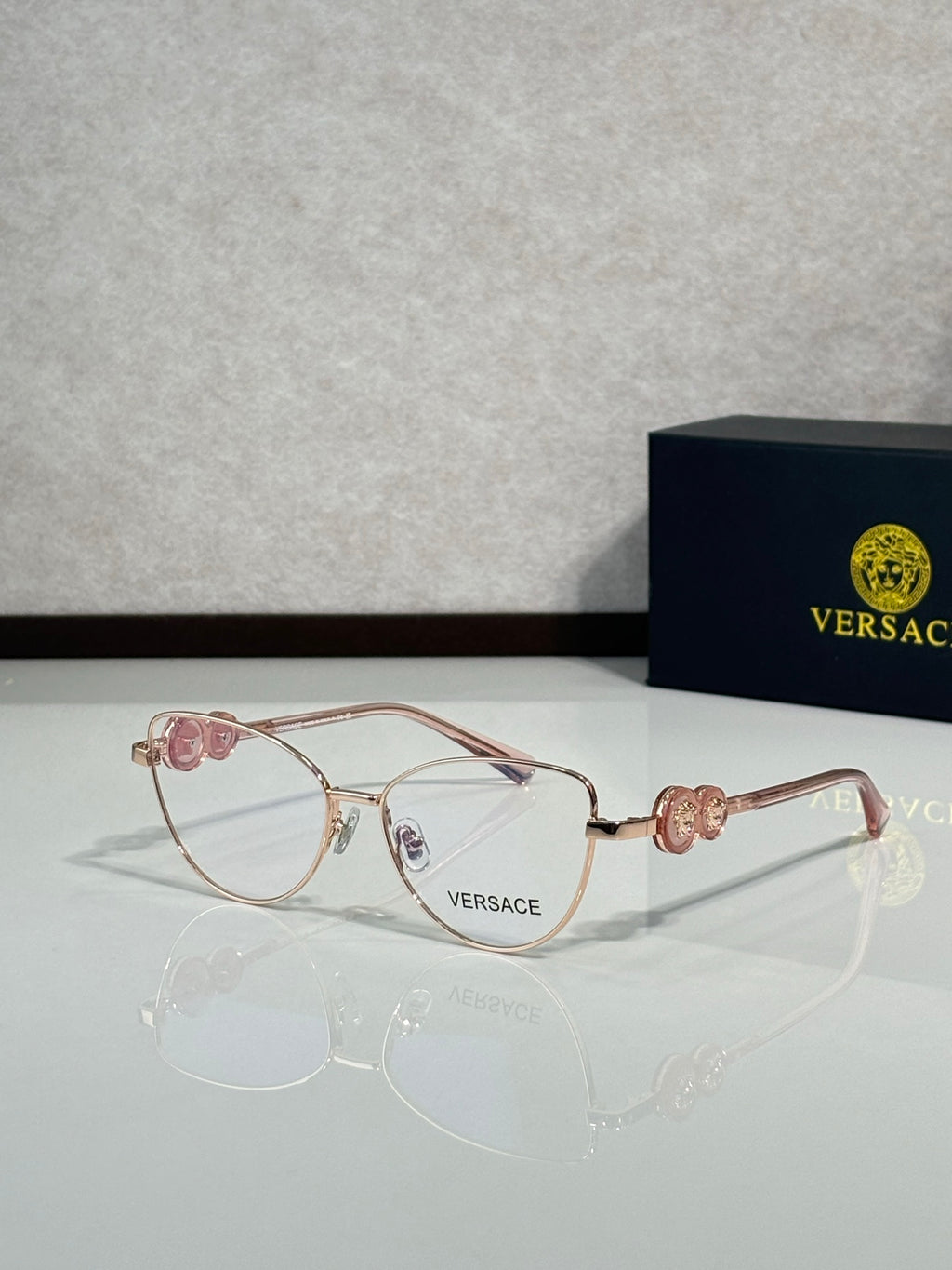 Versace aviator eyeglasses with rose-gold frame and clear lenses