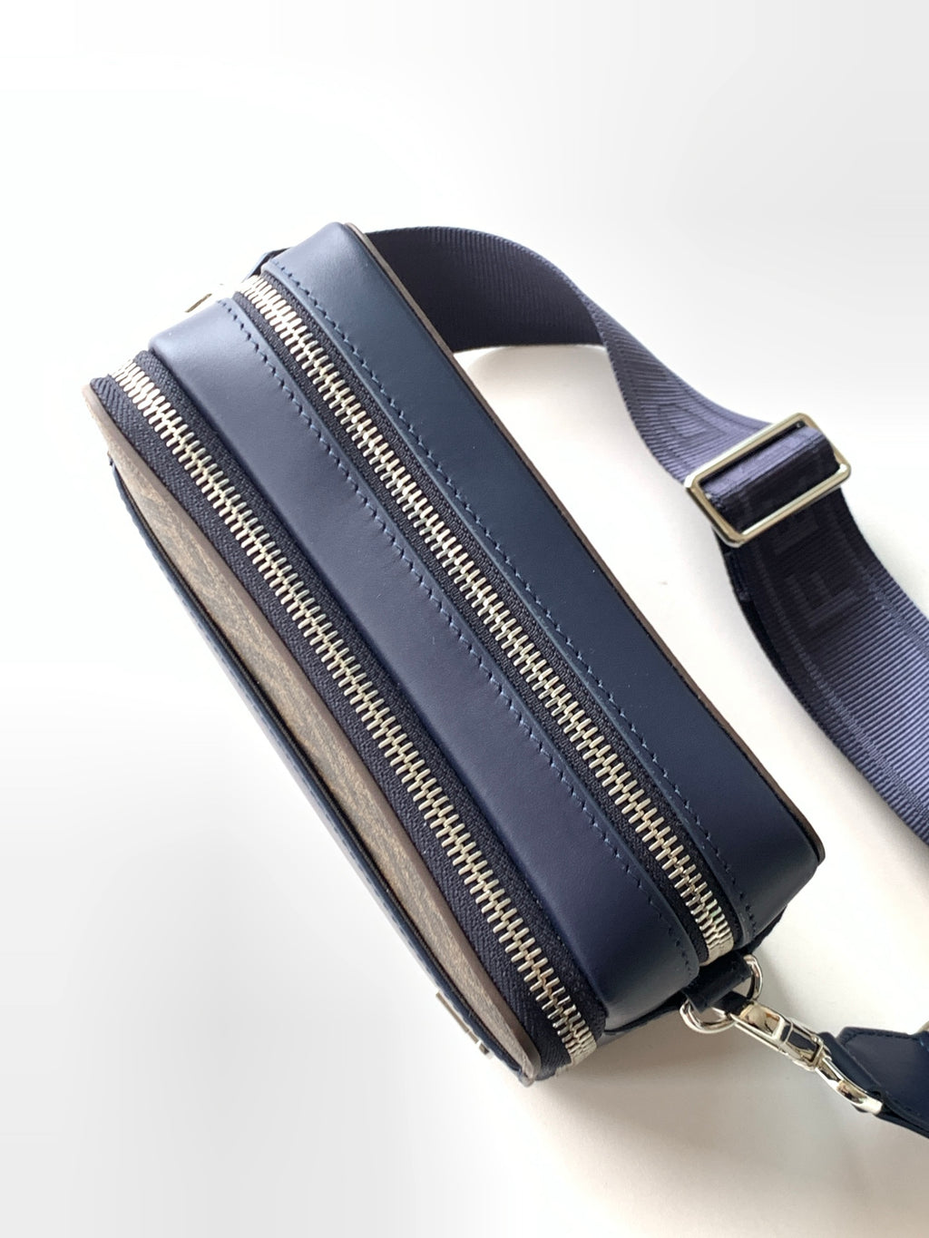 Fendi navy top-zip bag with wide strap, gold zipper tracks, and structured sides.