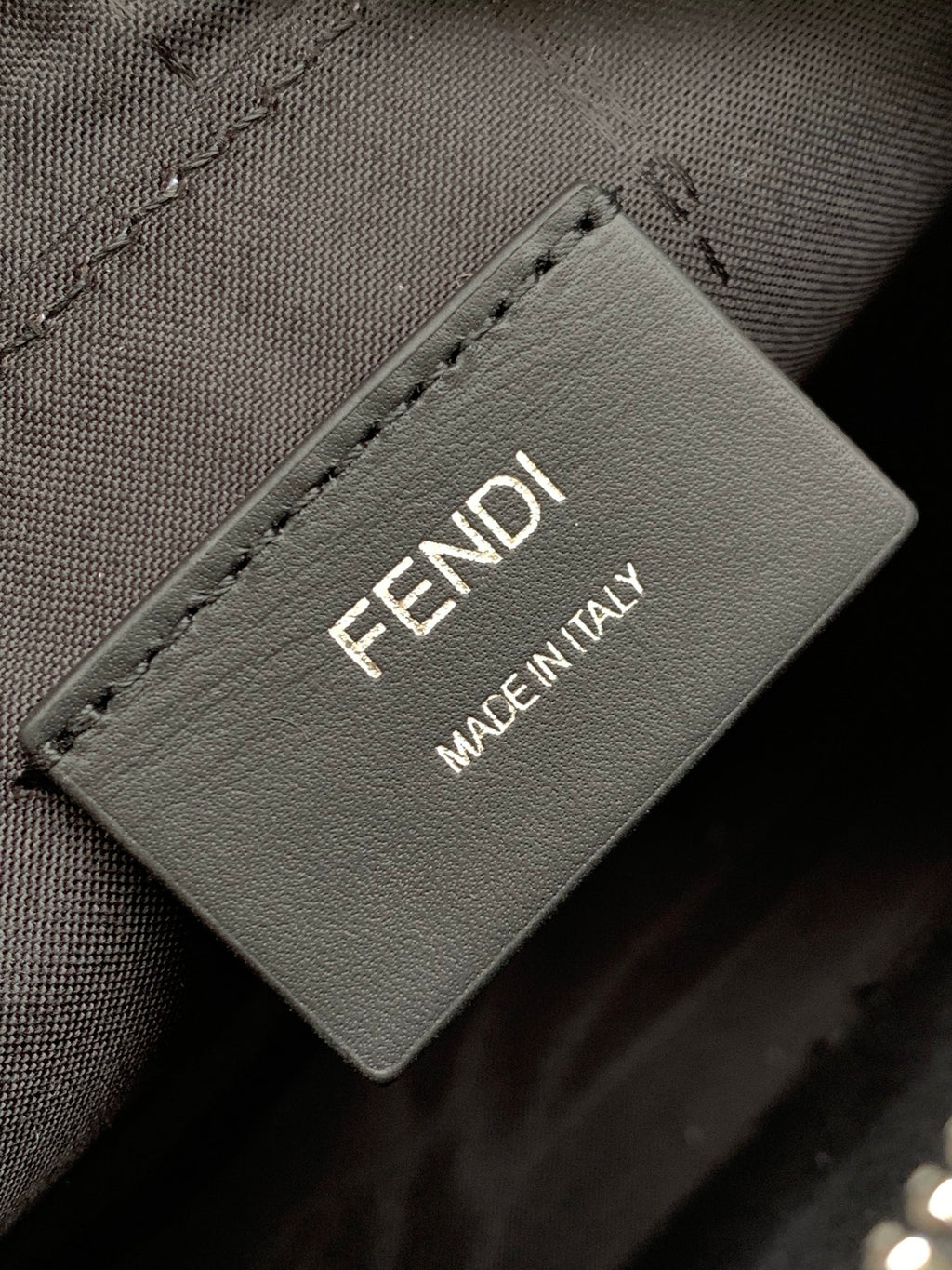 Label patch on crossbody bag reading FENDI MADE IN ITALY