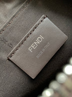 Fabric lining label with Fendi logo and small brand text on dark bag