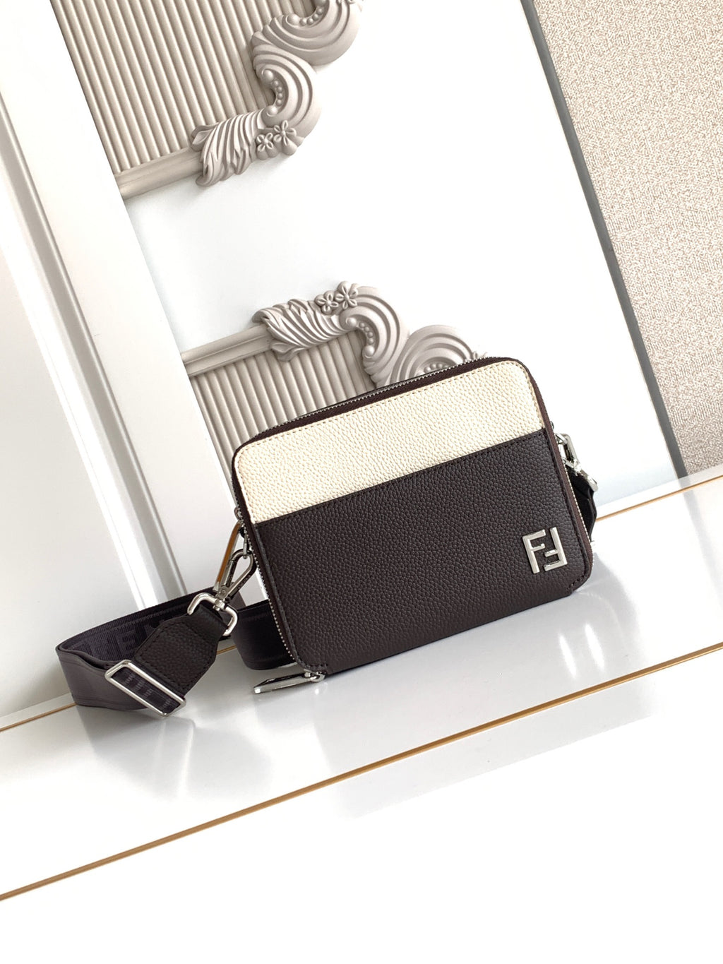 Fendi bag with textured leather, two-tone front, top zip, and shoulder strap