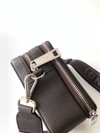 Textured leather mini bag with keyring hardware and dual zip; adjustable strap