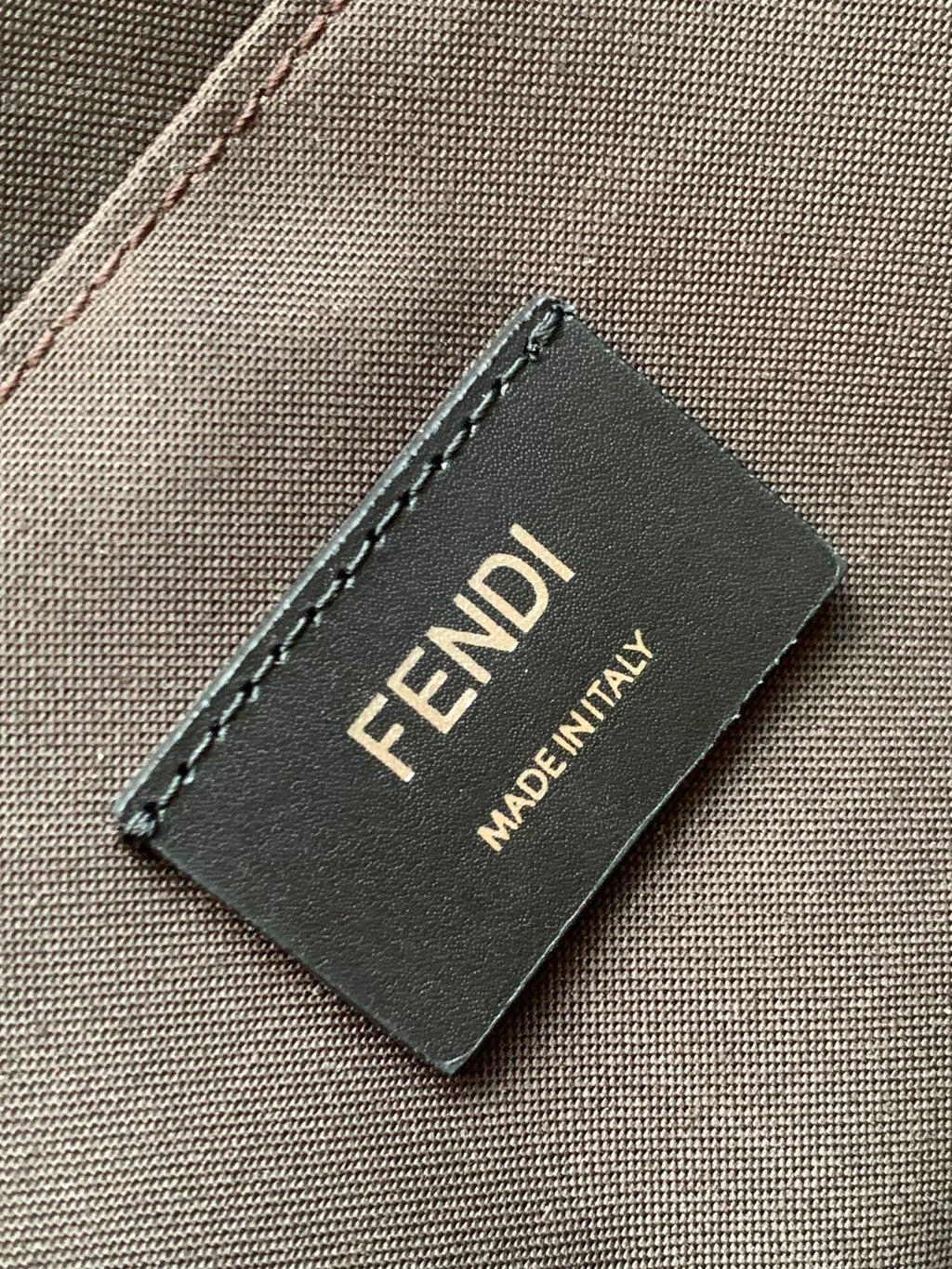 Fendi Made in Italy logo label on gray fabric