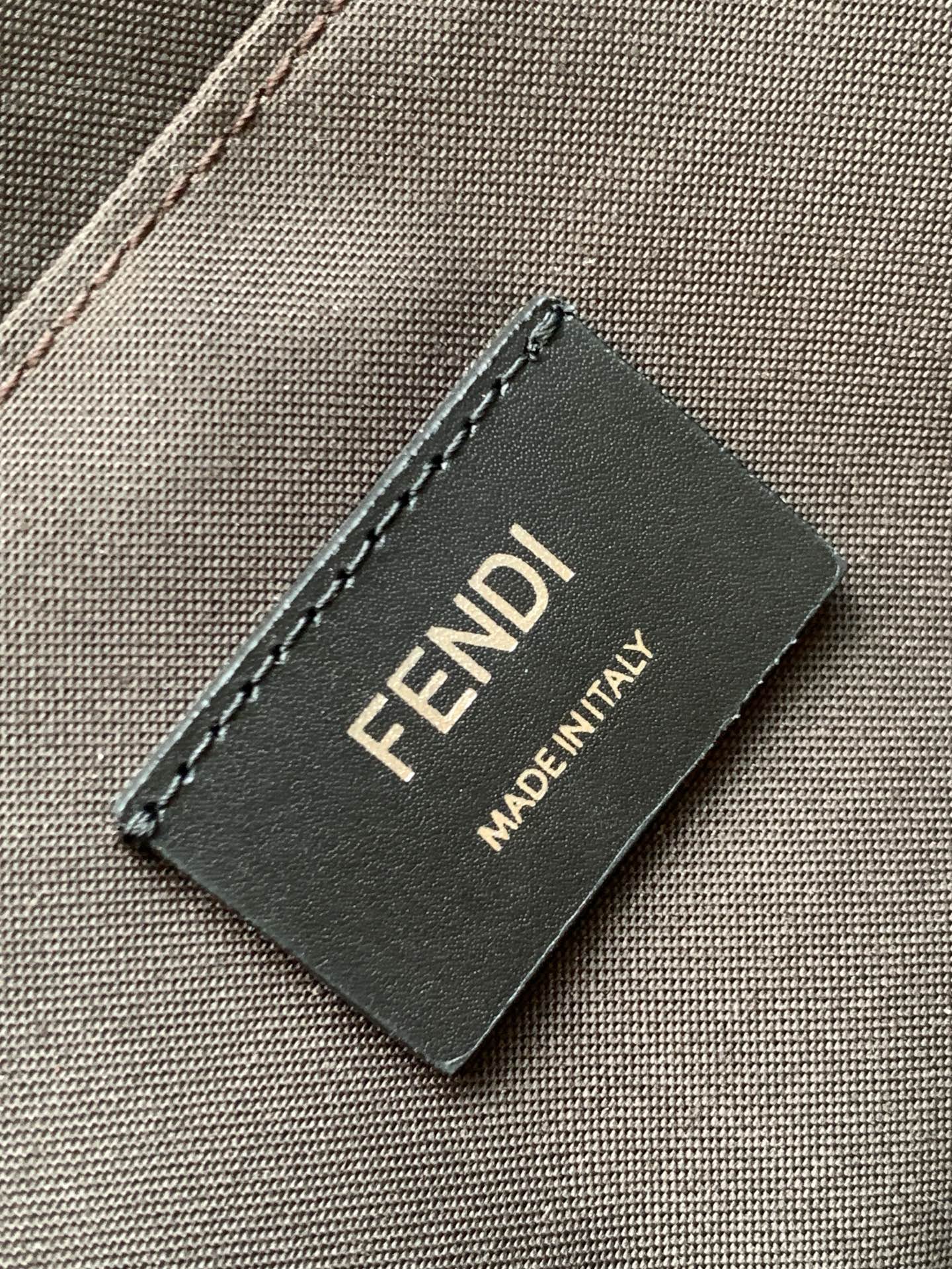 Fendi Made in Italy logo label on gray fabric