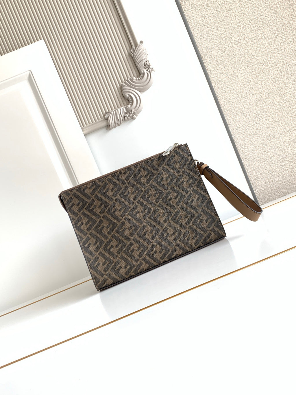 Fendi logo clutch bag with wrist strap and top zip closure