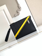 Fendi bag with black logo fabric, yellow trim, and top zip closure