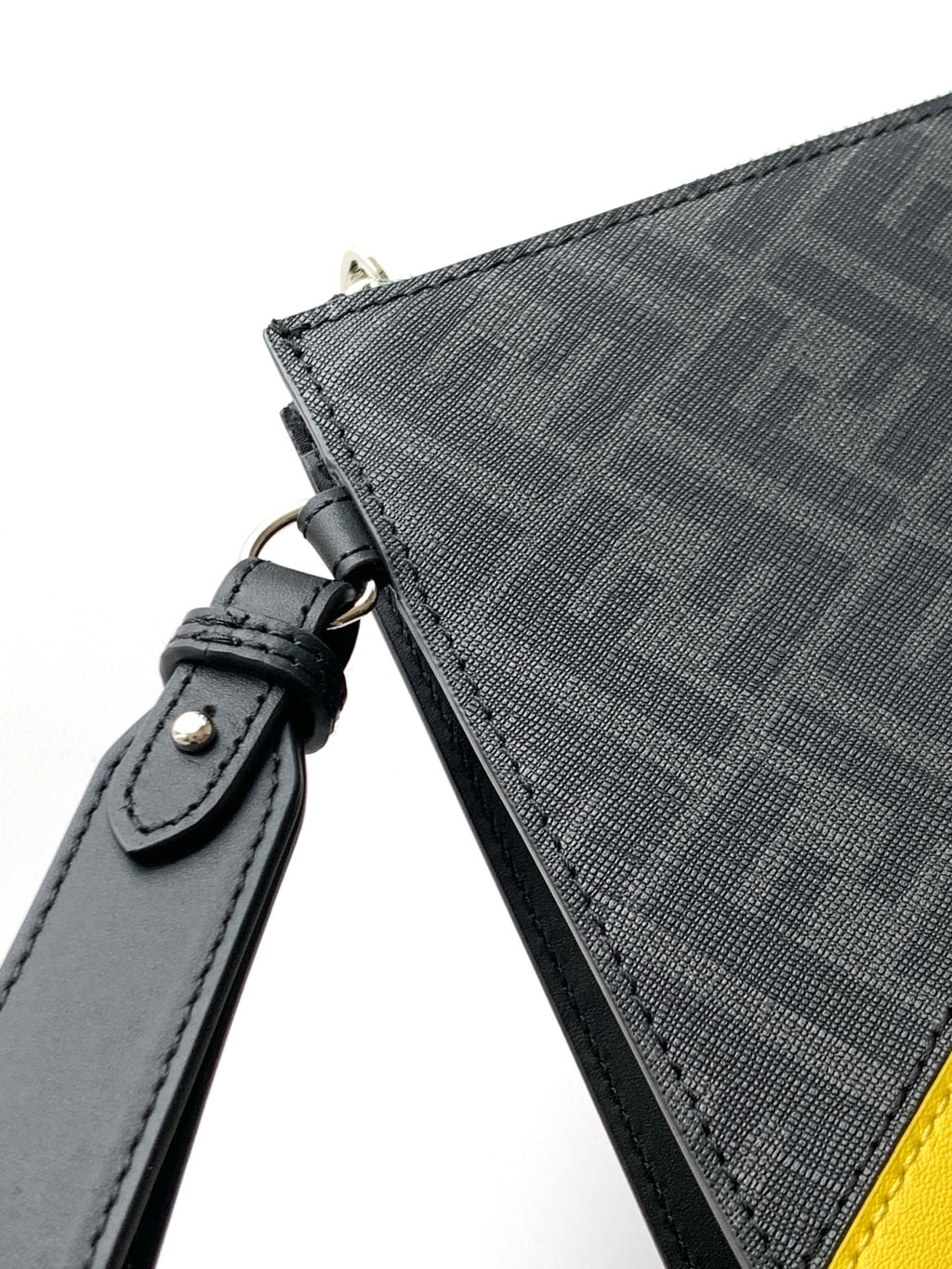 Fendi bag strap attachment in dark leather on textured fabric