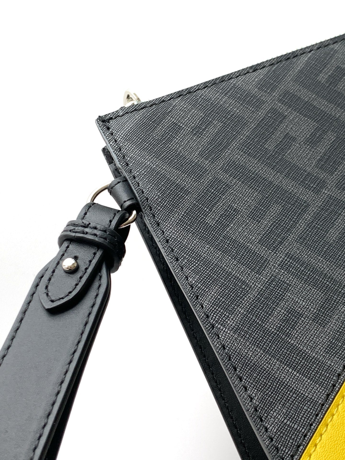 Fendi bag strap attachment in dark leather on textured fabric