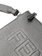 Textured leather bag with stitched Fendi logo and strap attachment